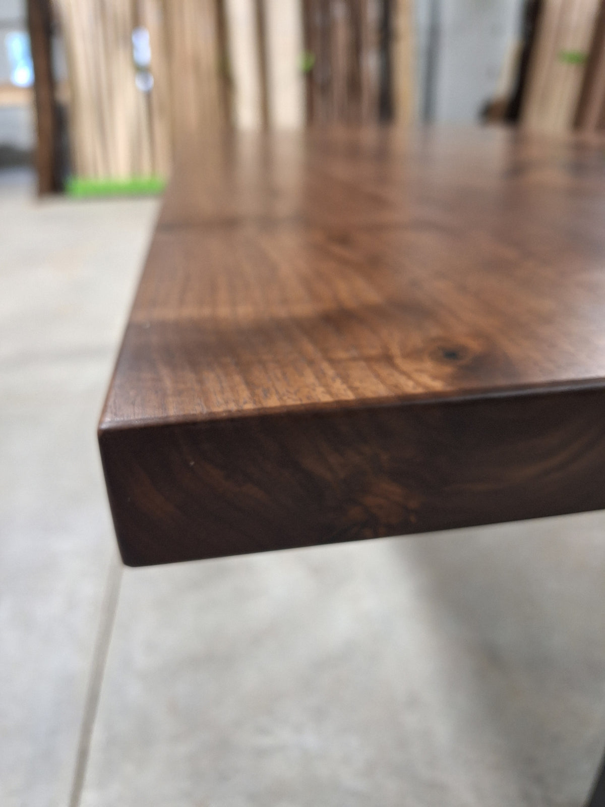 Edge detail of a solid walnut console table top