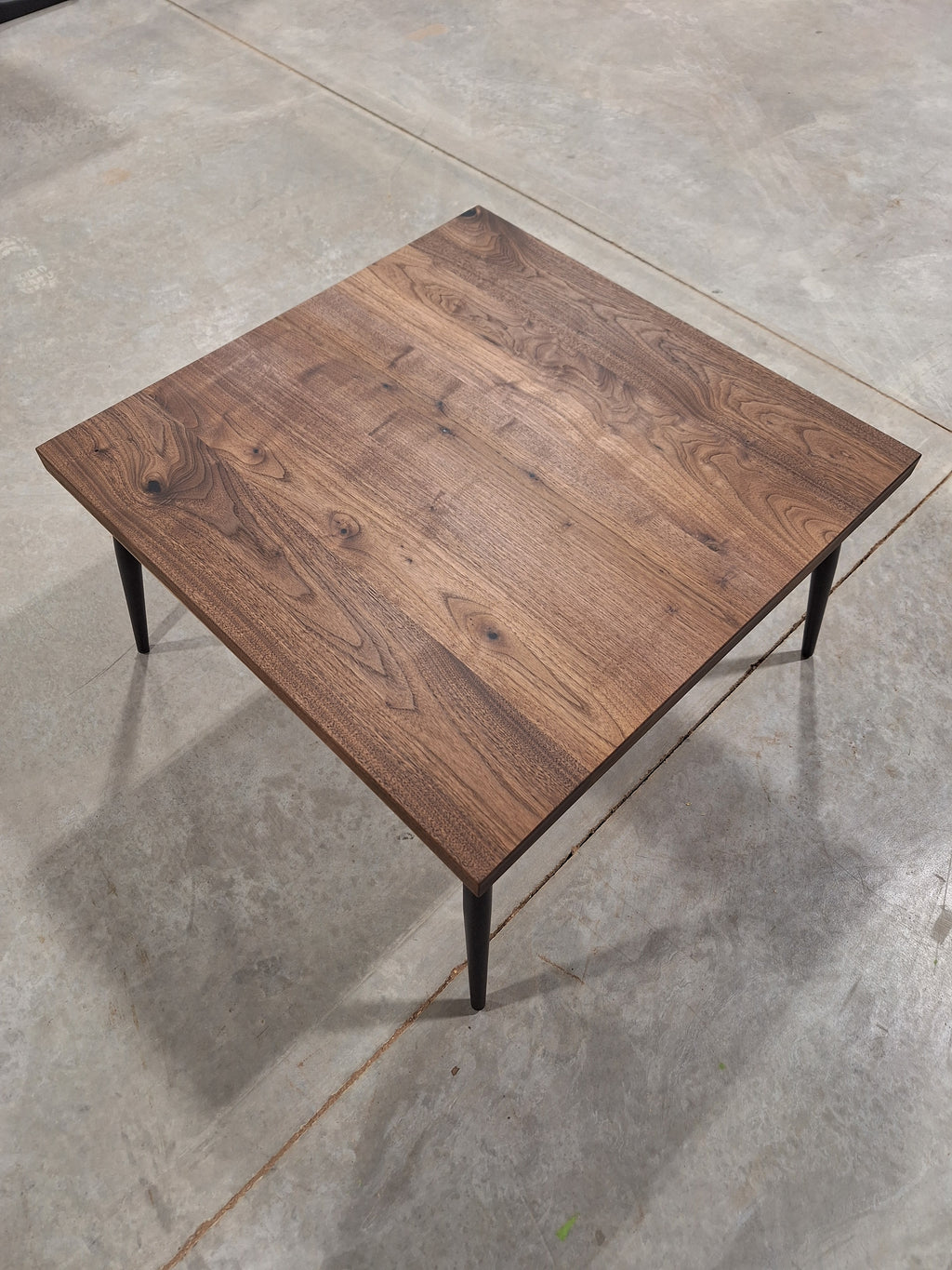 Solid walnut end table, overhead view, in our shop