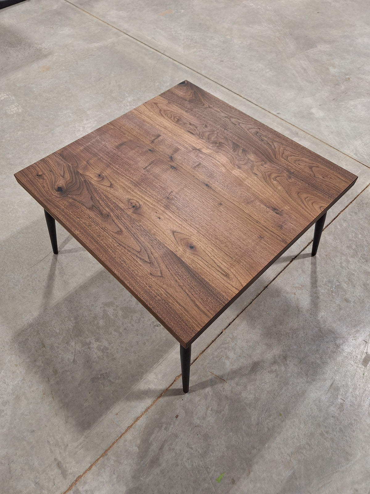 Solid walnut end table, overhead view, in our shop