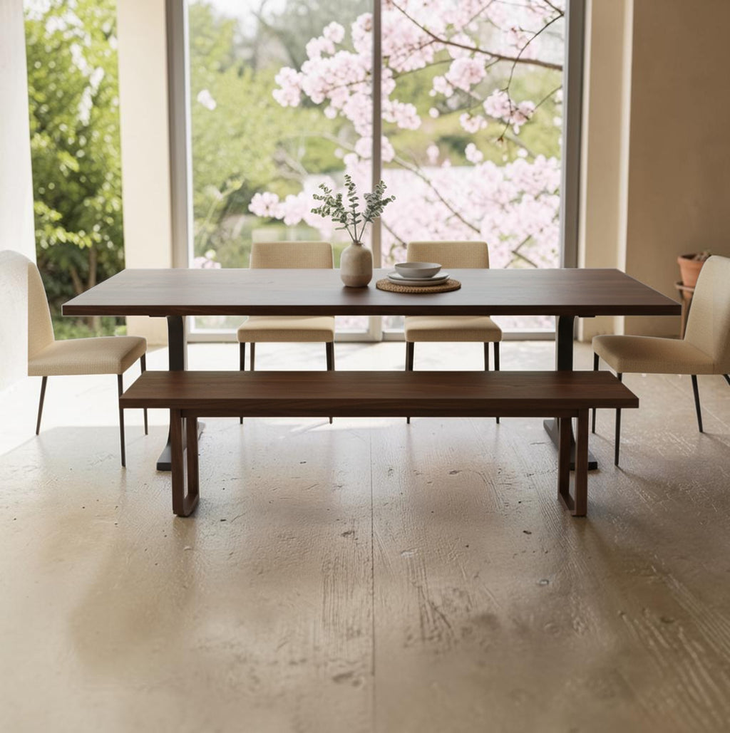 Solid walnut dining table and bench by a window (styled scene)