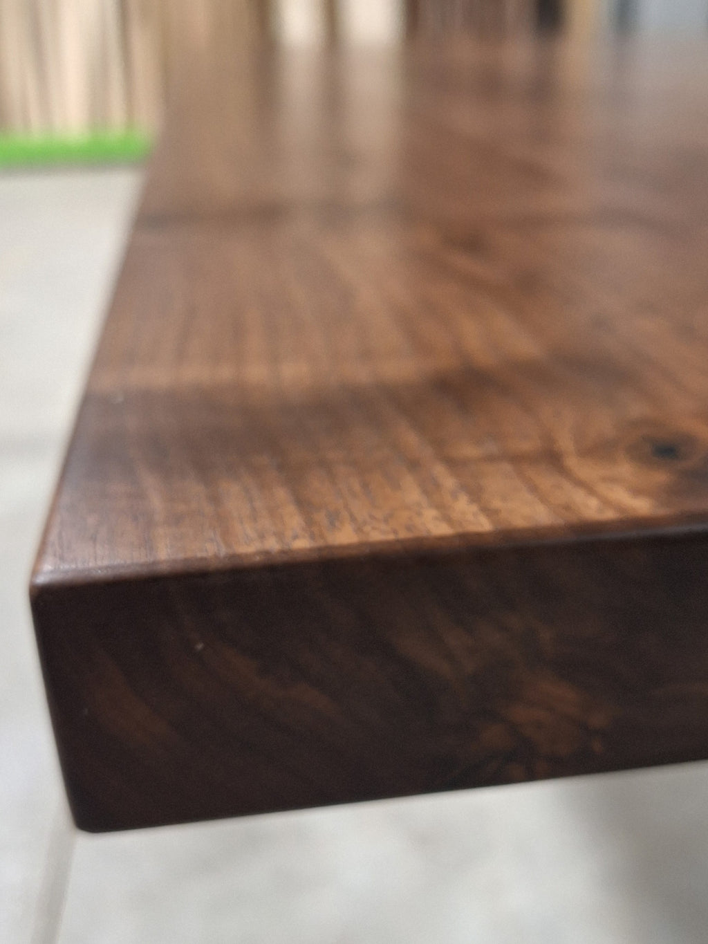 Edge profile of a solid walnut dining table top