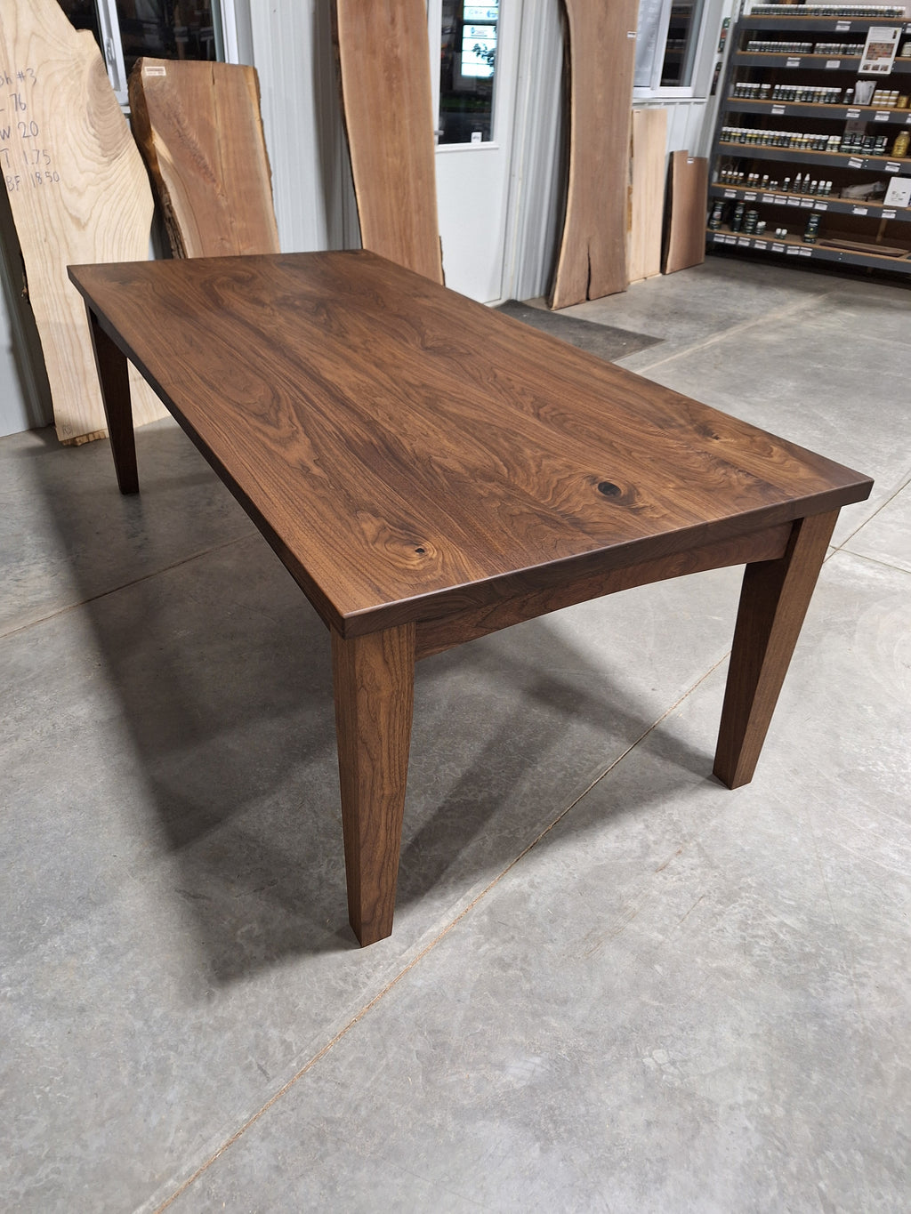 Solid walnut farmhouse dining table with solid wood legs, angled view