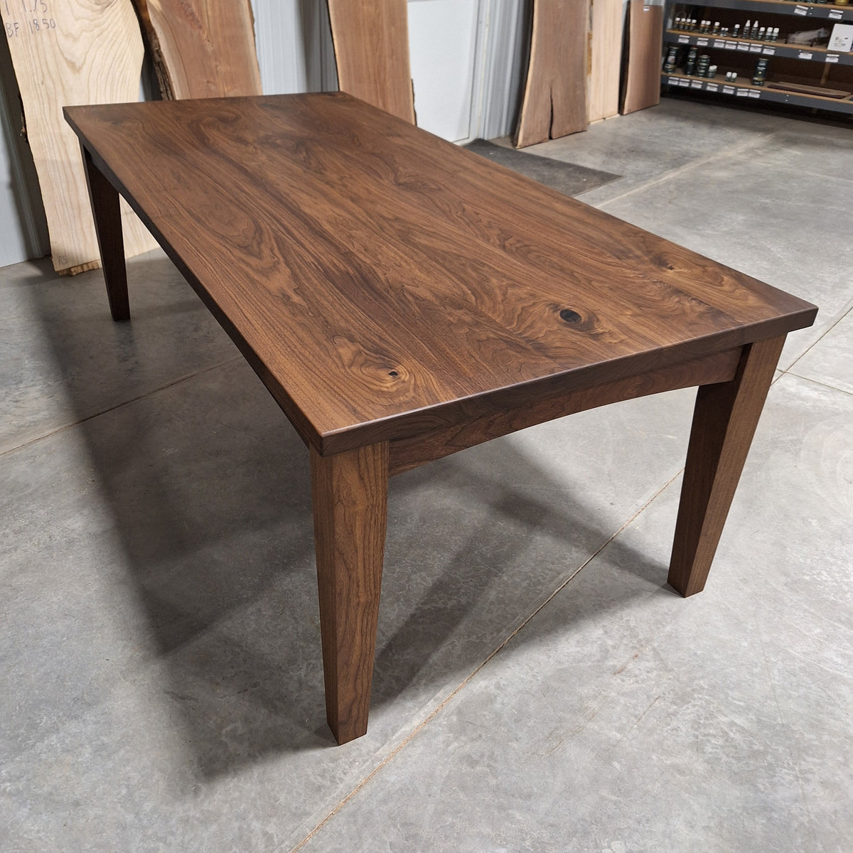 96 inch solid walnut farmhouse dining table on tapered solid wood legs in our Hiawatha, Iowa shop