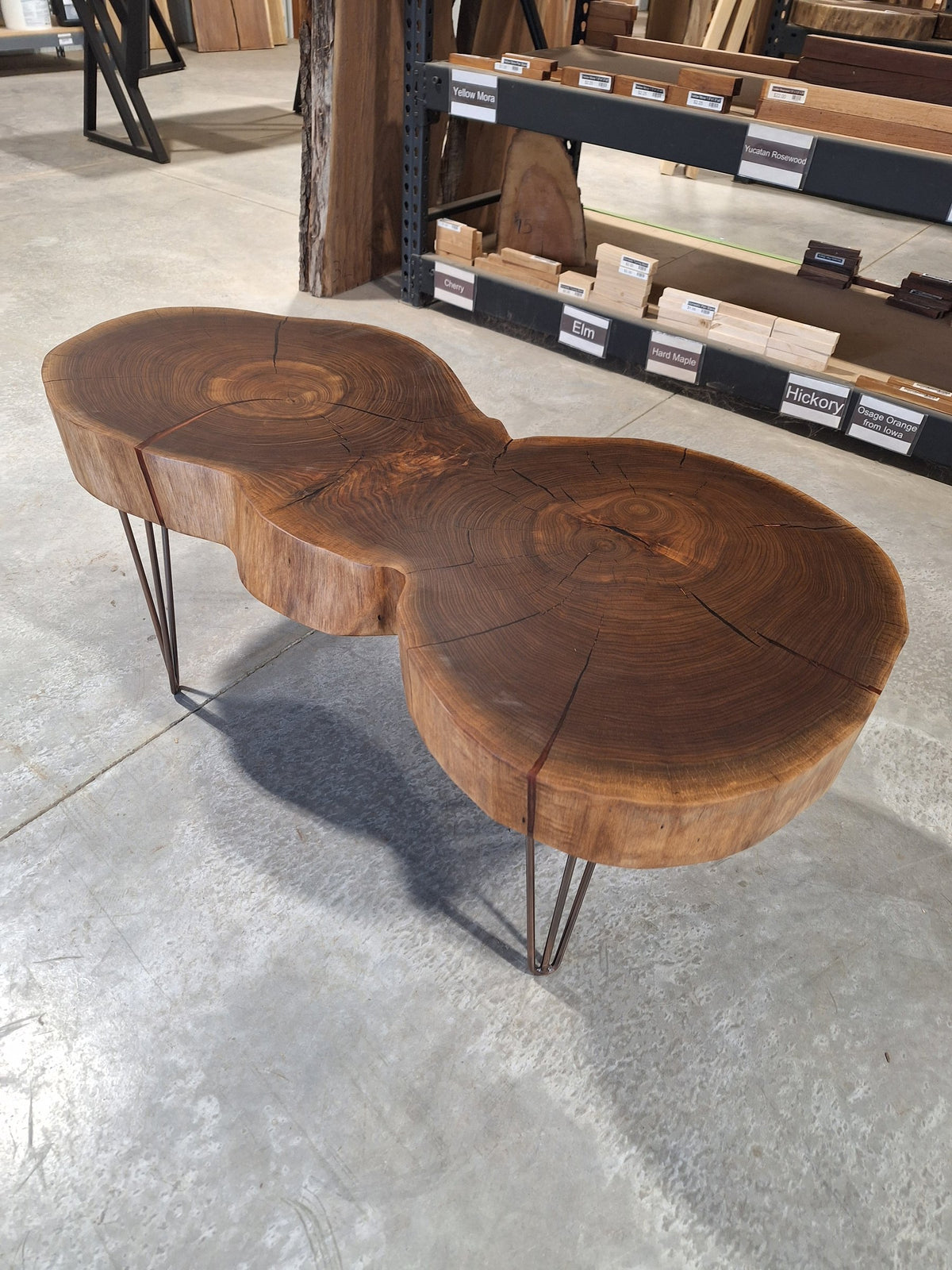Solid walnut double cookie coffee table with copper resin and copper hairpin legs, photographed in our Hiawatha shop (photo 1)
