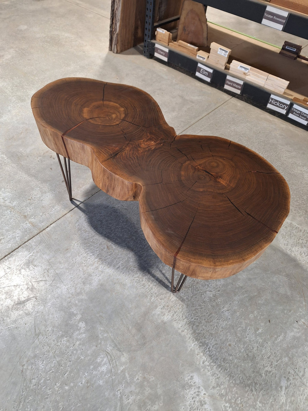 Solid walnut double cookie coffee table with copper resin and copper hairpin legs, photographed in our Hiawatha shop (photo 2)