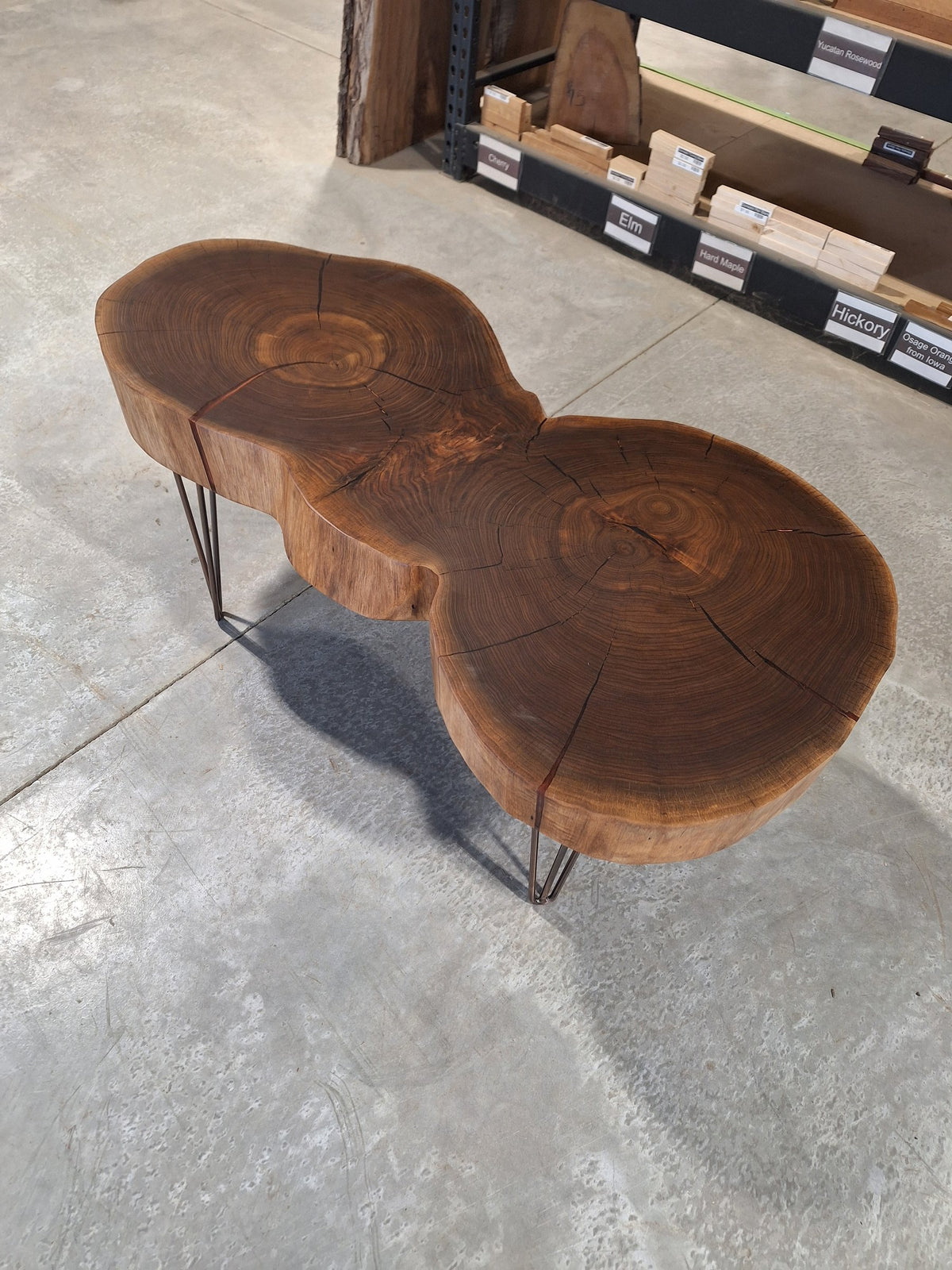 Solid walnut double cookie coffee table with copper resin and copper hairpin legs, photographed in our Hiawatha shop (photo 2)