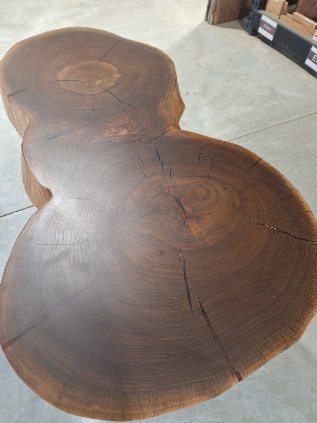 Solid walnut double cookie coffee table with copper resin and copper hairpin legs, photographed in our Hiawatha shop (photo 3)