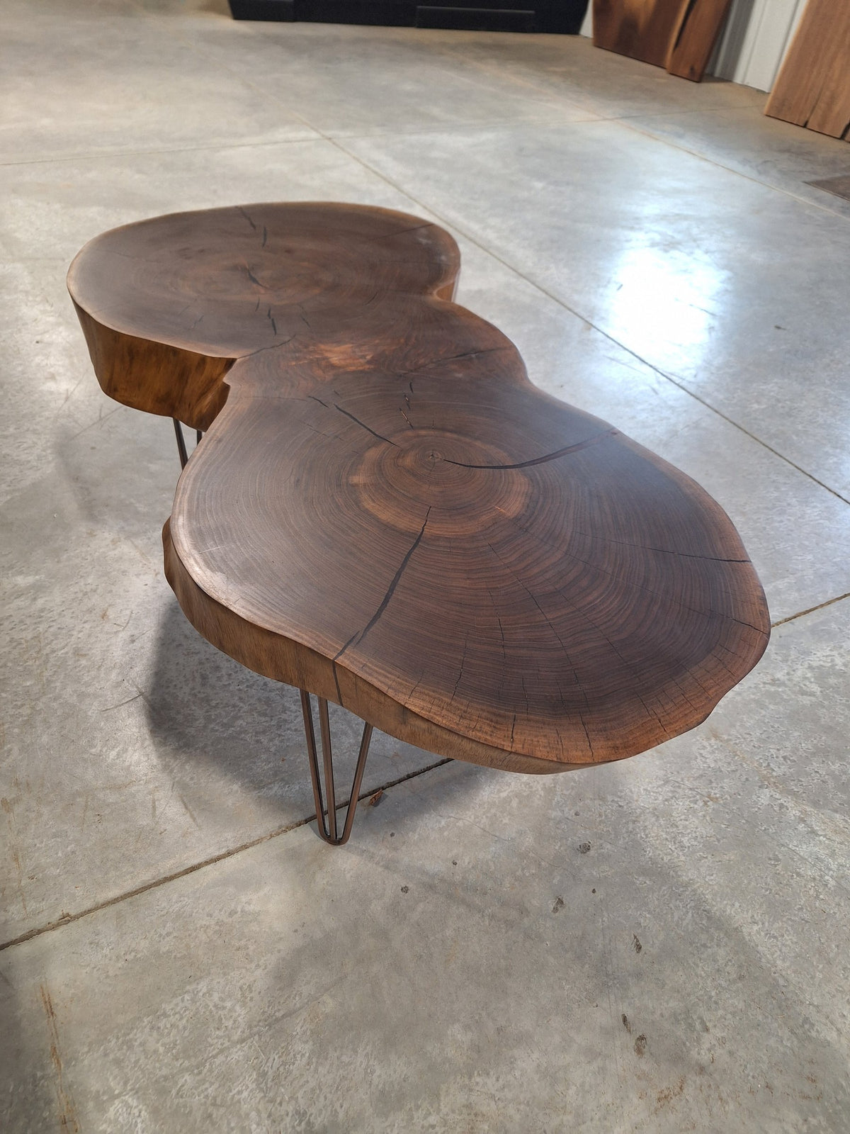 Solid walnut double cookie coffee table with copper resin and copper hairpin legs, photographed in our Hiawatha shop (photo 5)
