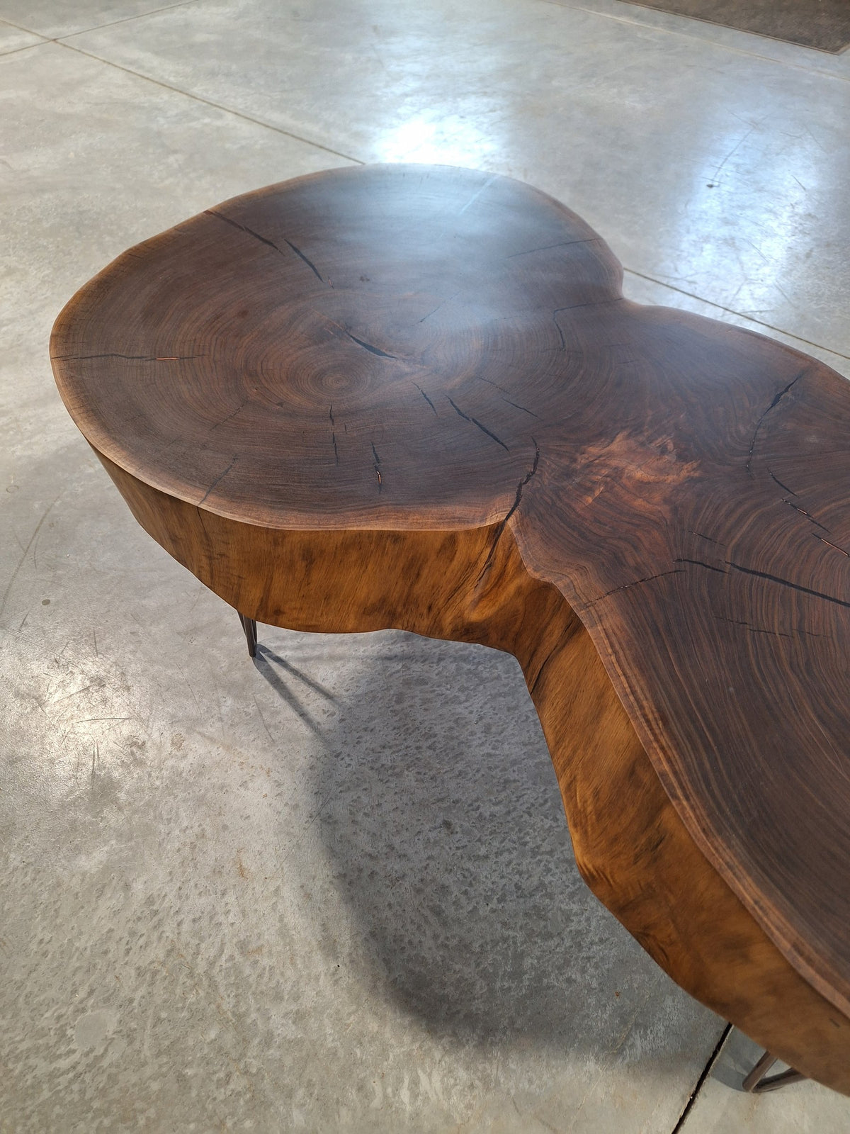 Solid walnut double cookie coffee table with copper resin and copper hairpin legs, photographed in our Hiawatha shop (photo 6)