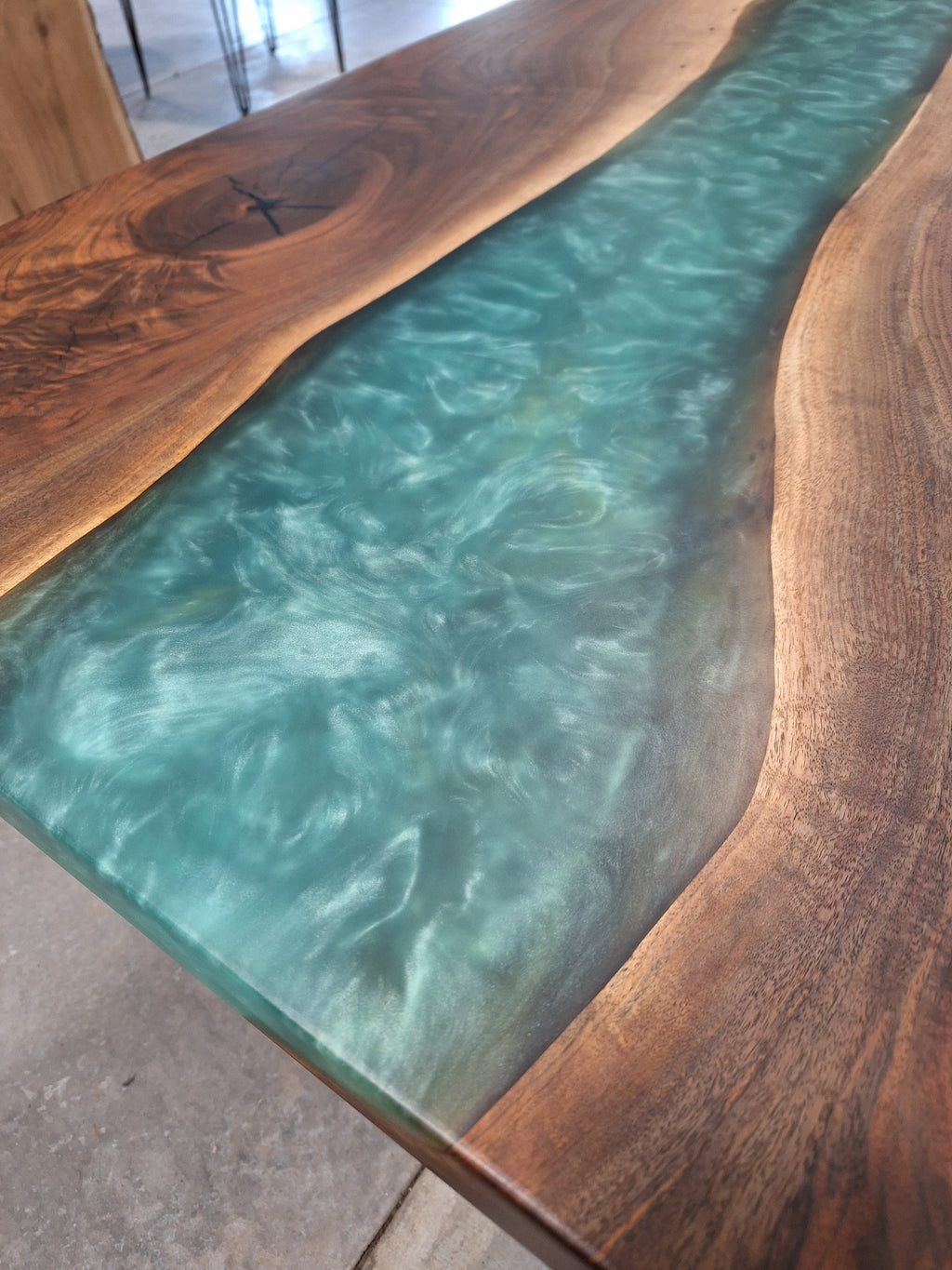 Solid walnut river dining table with green epoxy river and black metal legs, photographed in our Hiawatha shop (photo 5)