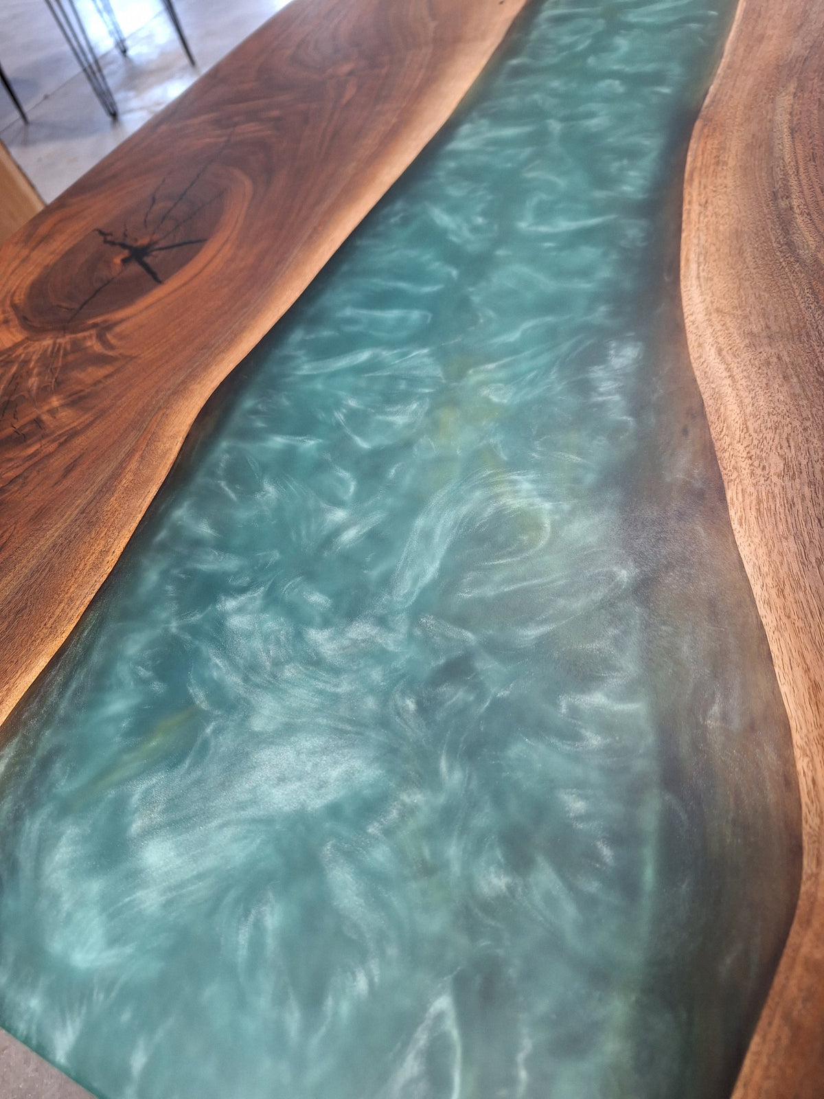 Solid walnut river dining table with green epoxy river and black metal legs, photographed in our Hiawatha shop (photo 7)