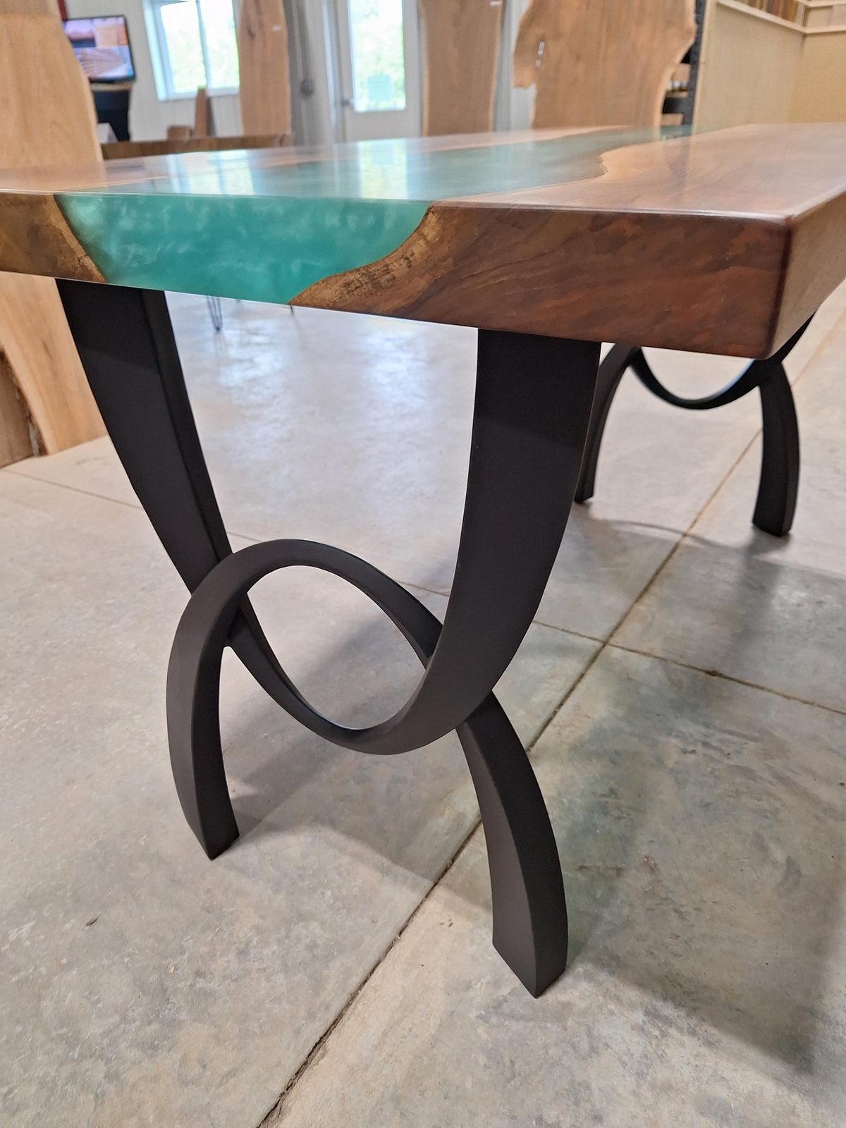 Solid walnut river dining table with green epoxy river and black metal legs, photographed in our Hiawatha shop (photo 9)